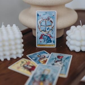 Artful display of tarot cards with stylish wax candles for a mystical ambiance.