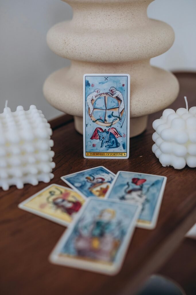 Artful display of tarot cards with stylish wax candles for a mystical ambiance.